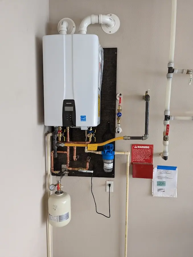 Professional plumber installing copper piping in a Larchmont home